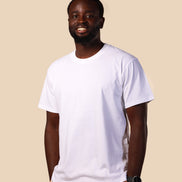 Man wearing a plain white t-shirt against a beige background